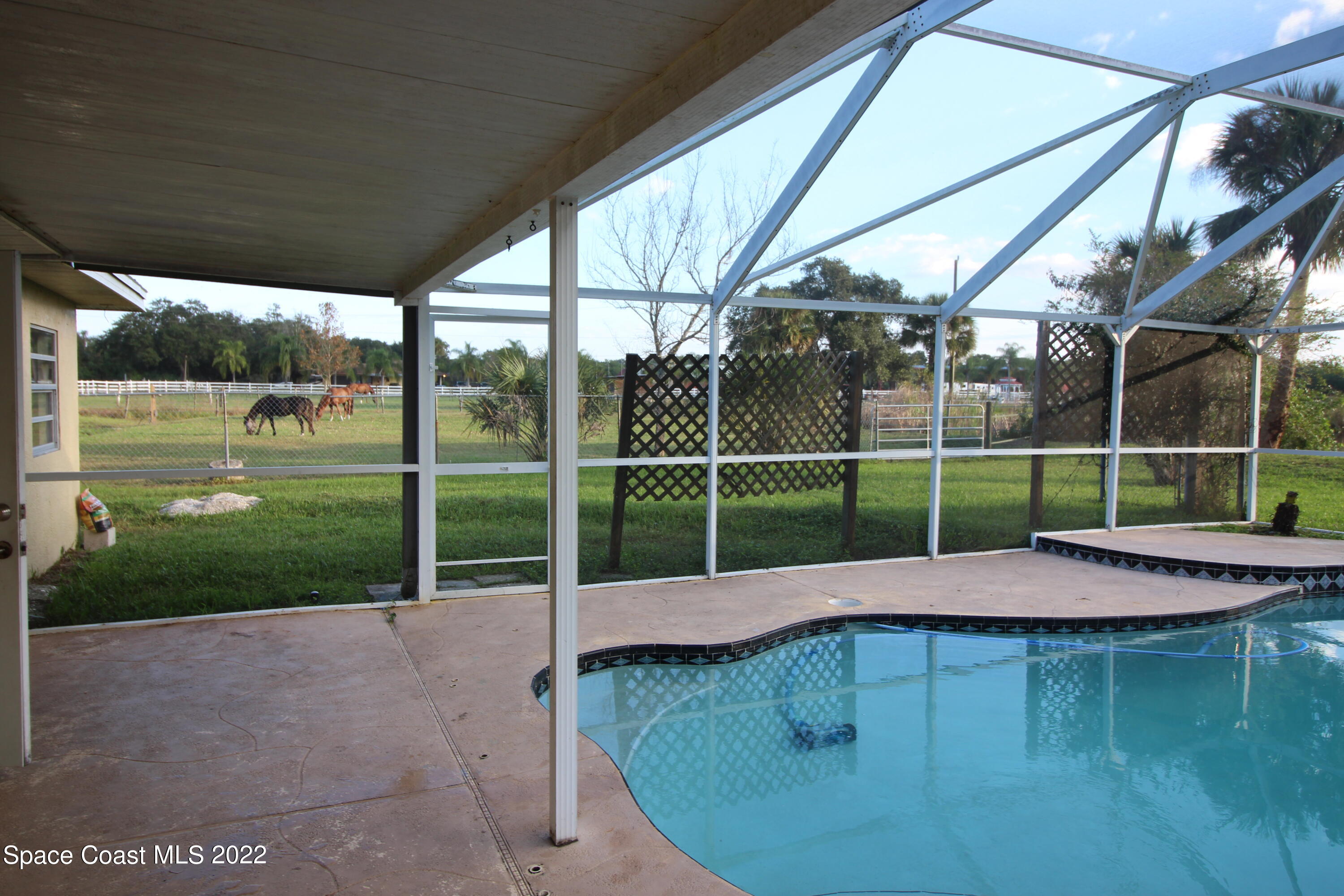 525 North Burnett Road Cocoa, FL 32926 - Photo 11 of 14 a white house with a yard in front of it