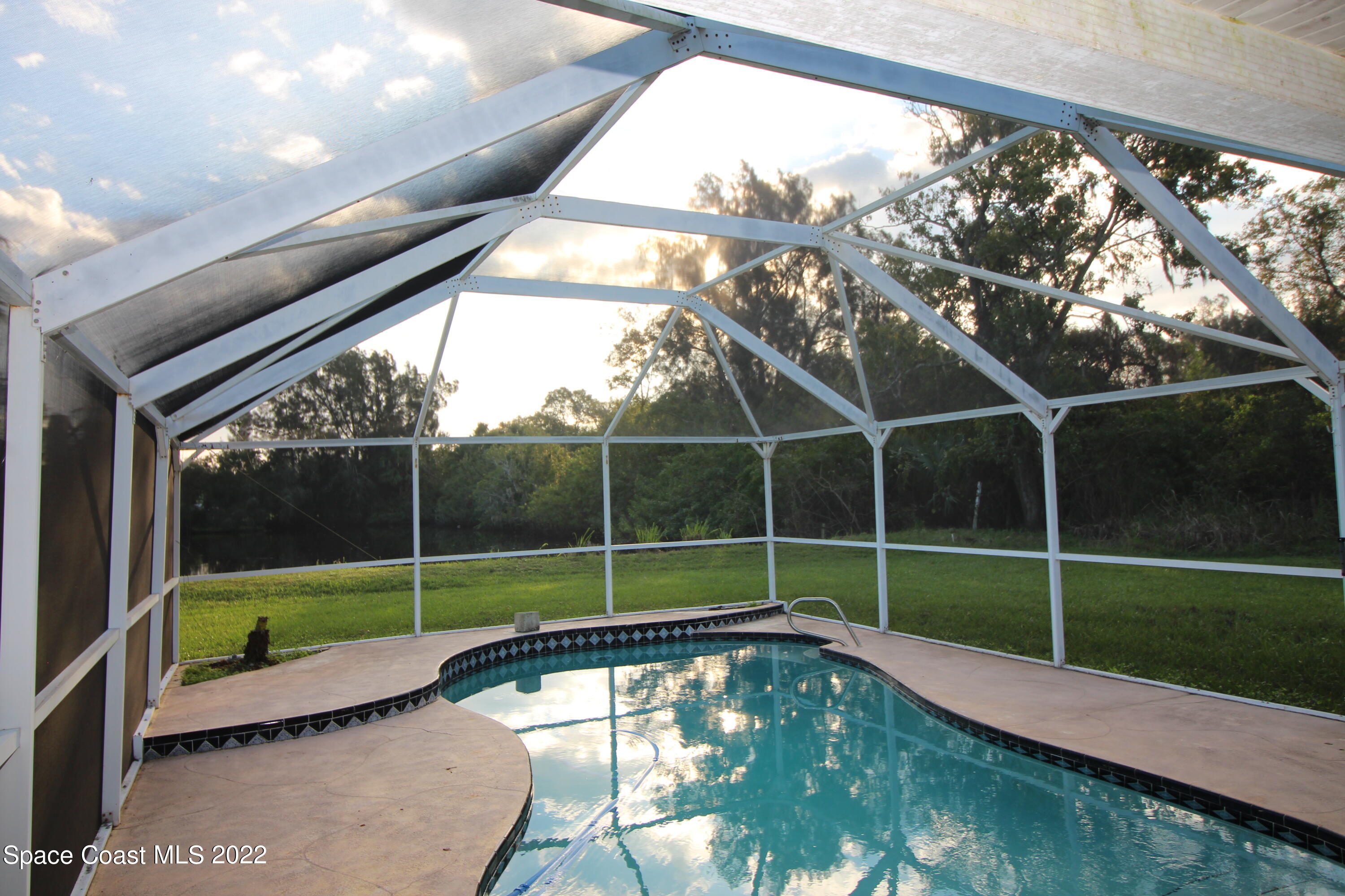 525 North Burnett Road Cocoa, FL 32926 - Photo 2 of 14 a view of a swimming pool with a yard from a balcony