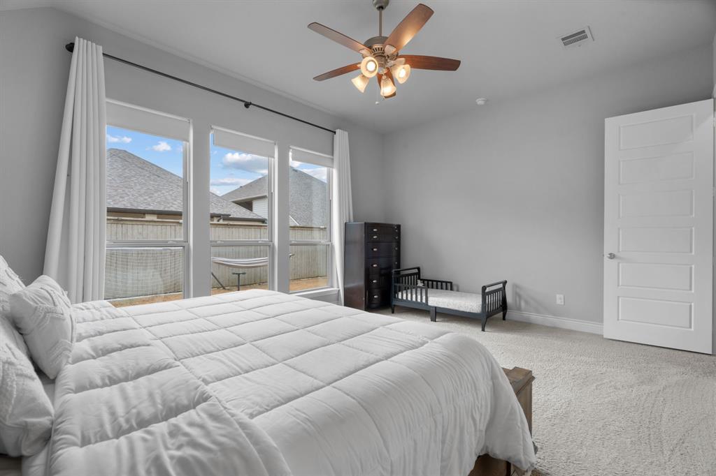 2425 Robin Way Northlake, TX 76247 - Photo 16 of 40 a bedroom with a bed and a large window