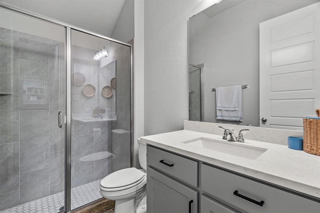 2425 Robin Way Northlake, TX 76247 - Photo 20 of 40 a bathroom with a sink a toilet and shower