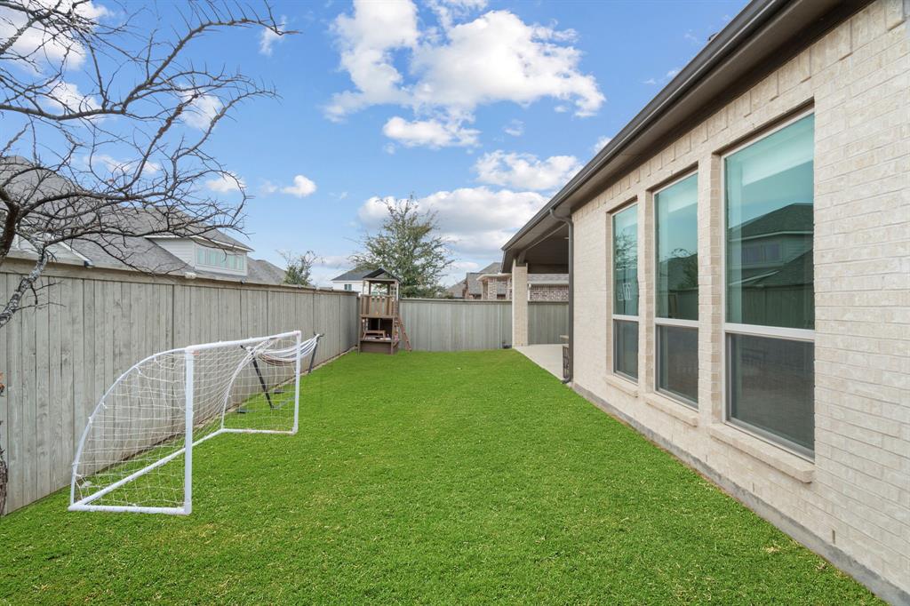 2425 Robin Way Northlake, TX 76247 - Photo 31 of 40 a view of backyard with furniture and a yard