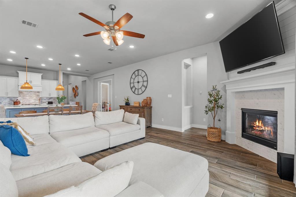 2425 Robin Way Northlake, TX 76247 - Photo 7 of 40 a living room with furniture a fireplace and a flat screen tv