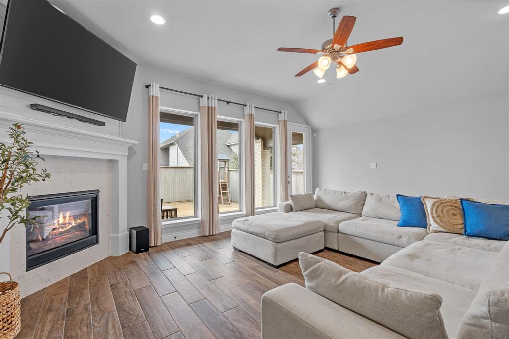 2425 Robin Way Northlake, TX 76247 - Photo 8 of 40 a living room with furniture a fireplace and a flat screen tv