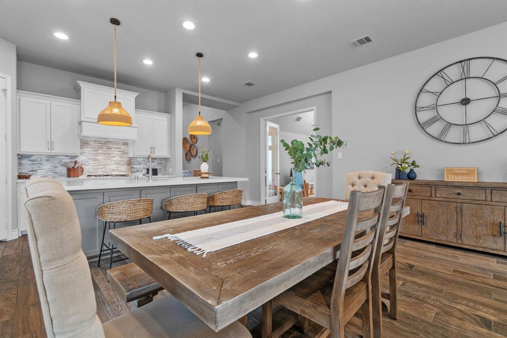 2425 Robin Way Northlake, TX 76247 - Photo 10 of 40 a dining table with wooden floor and kitchen view