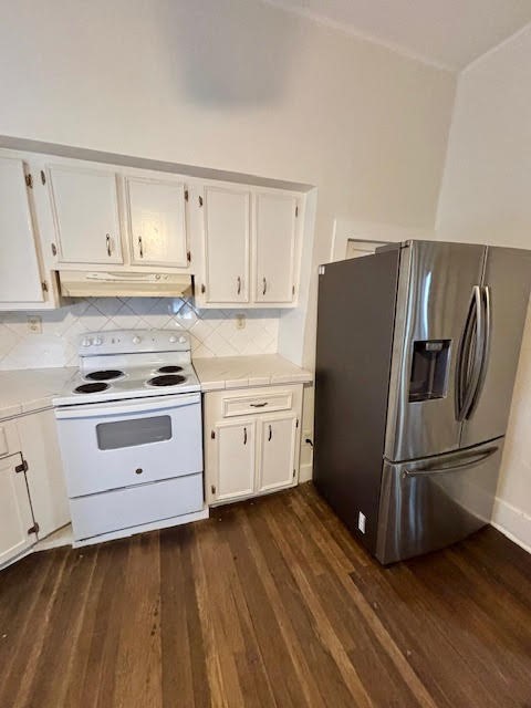 210 East Phillips Street Conroe, TX 77301 - Photo 11 of 27 a kitchen with wooden floors and appliances