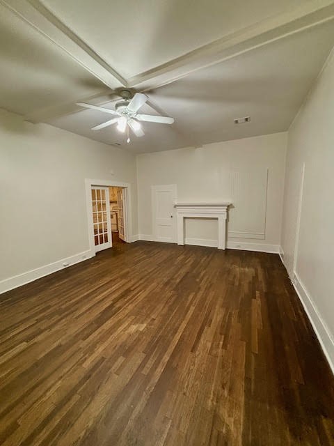 210 East Phillips Street Conroe, TX 77301 - Photo 15 of 27 an empty room with wooden floor and windows