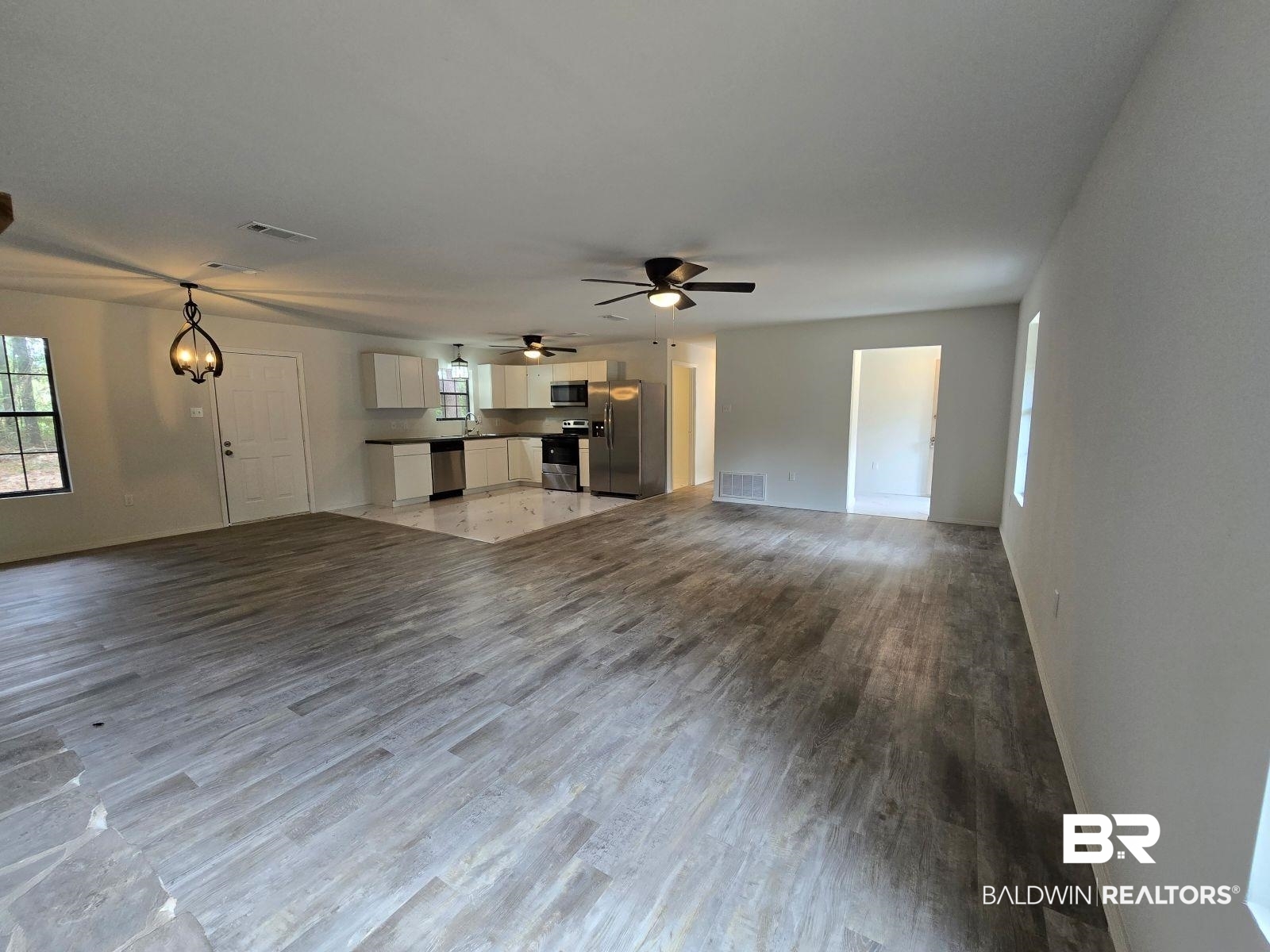 1600 Blair Road Brewton, AL 36426 - Photo 3 of 15 Unfurnished living room with wood-type flooring and ceiling fan