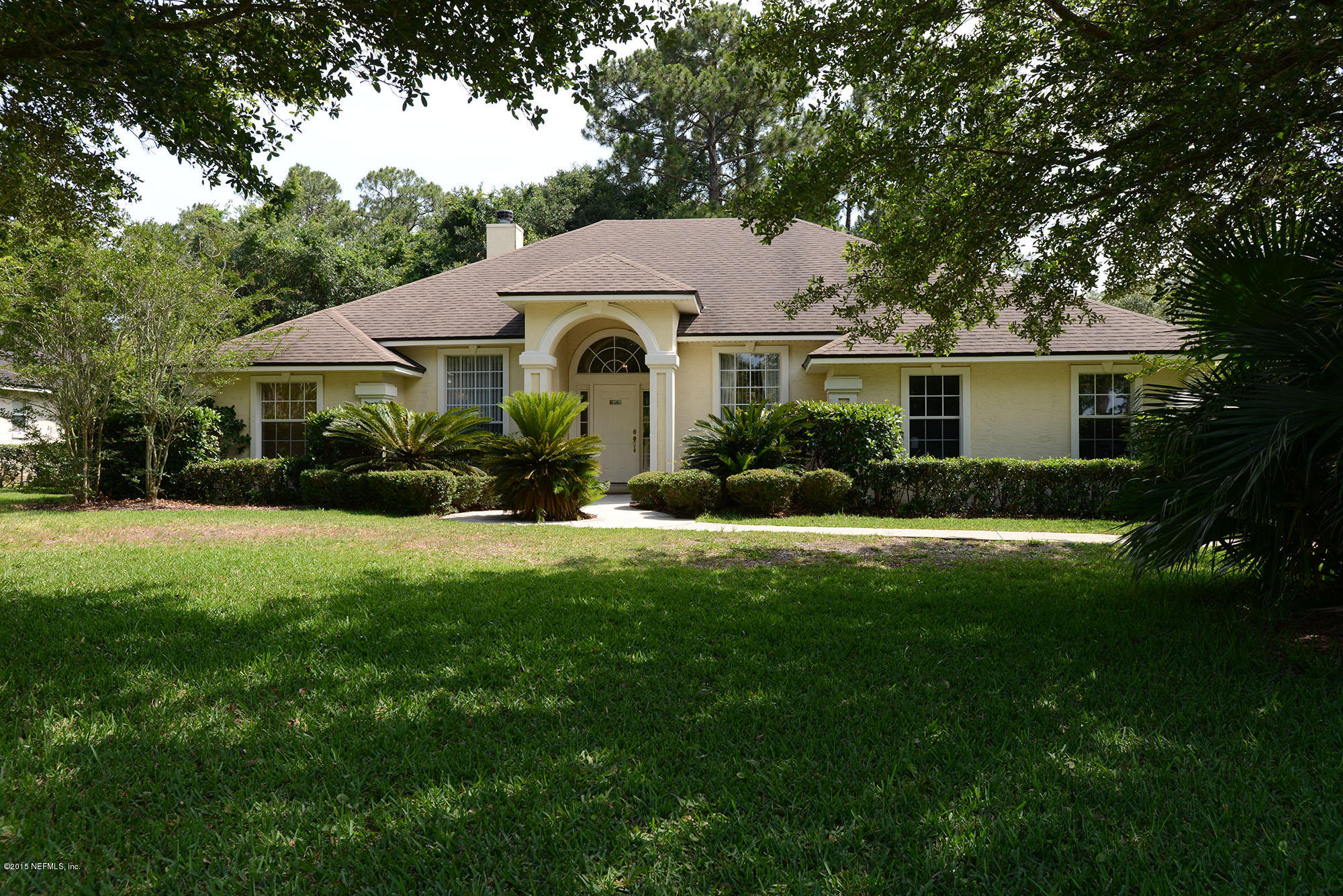 a front view of house with yard and green space
