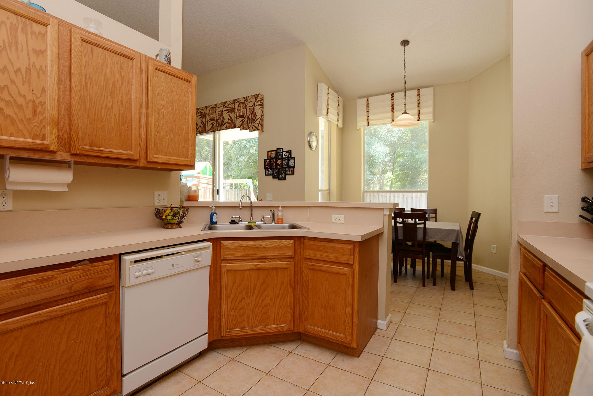 226 Riviera Boulevard St. Augustine Shores, FL 32086 - Photo 11 of 26 a kitchen with a sink table and chairs