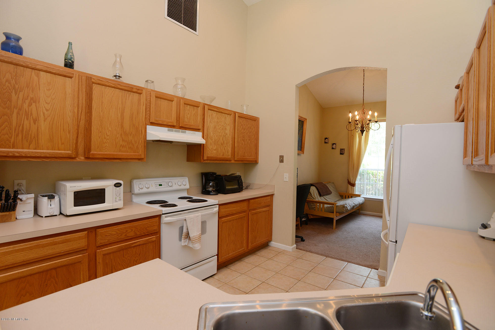 226 Riviera Boulevard St. Augustine Shores, FL 32086 - Photo 12 of 26 a kitchen with a sink dishwasher and a stove with wooden floor