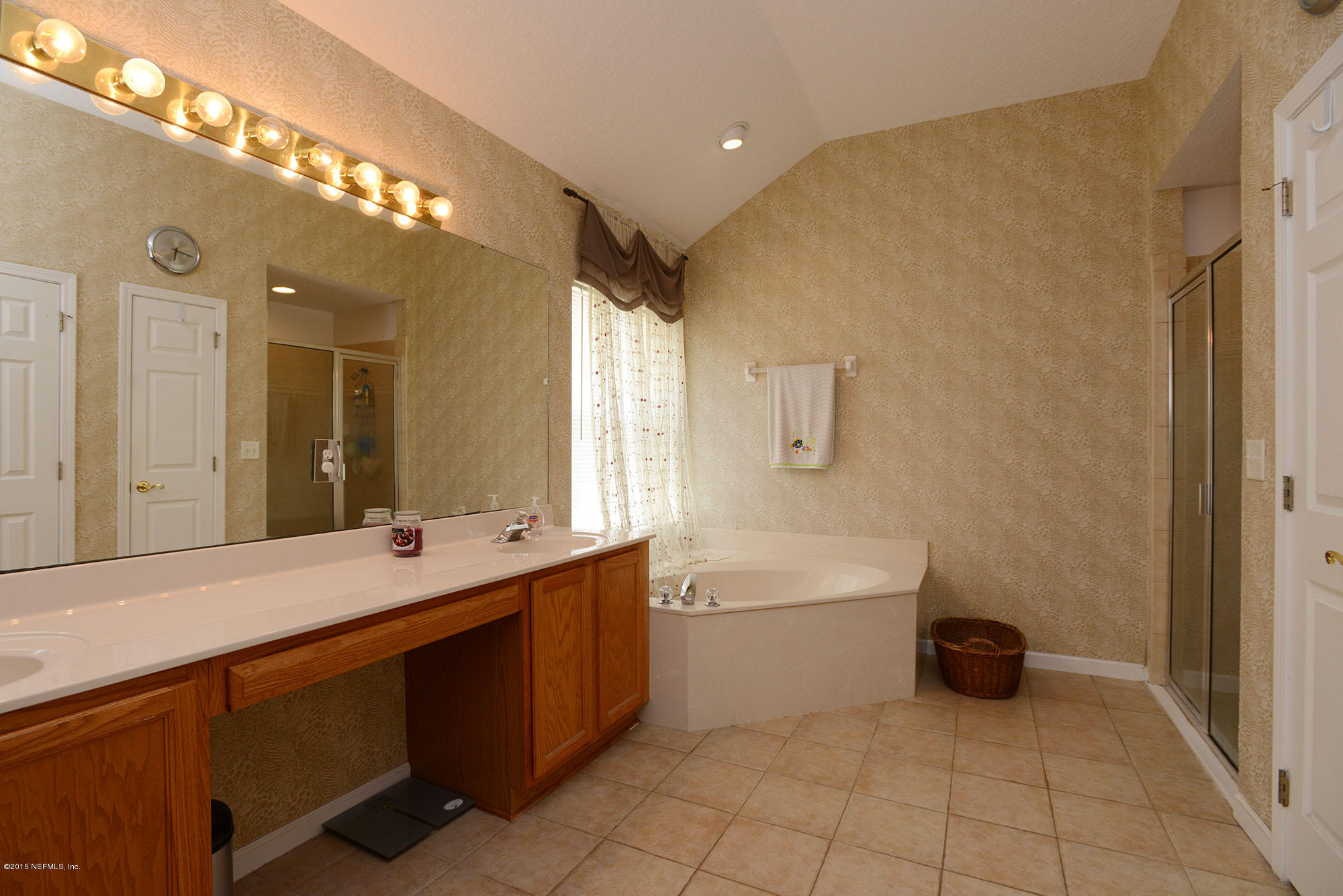 226 Riviera Boulevard St. Augustine Shores, FL 32086 - Photo 14 of 26 a bathroom with a tub a sink and mirror