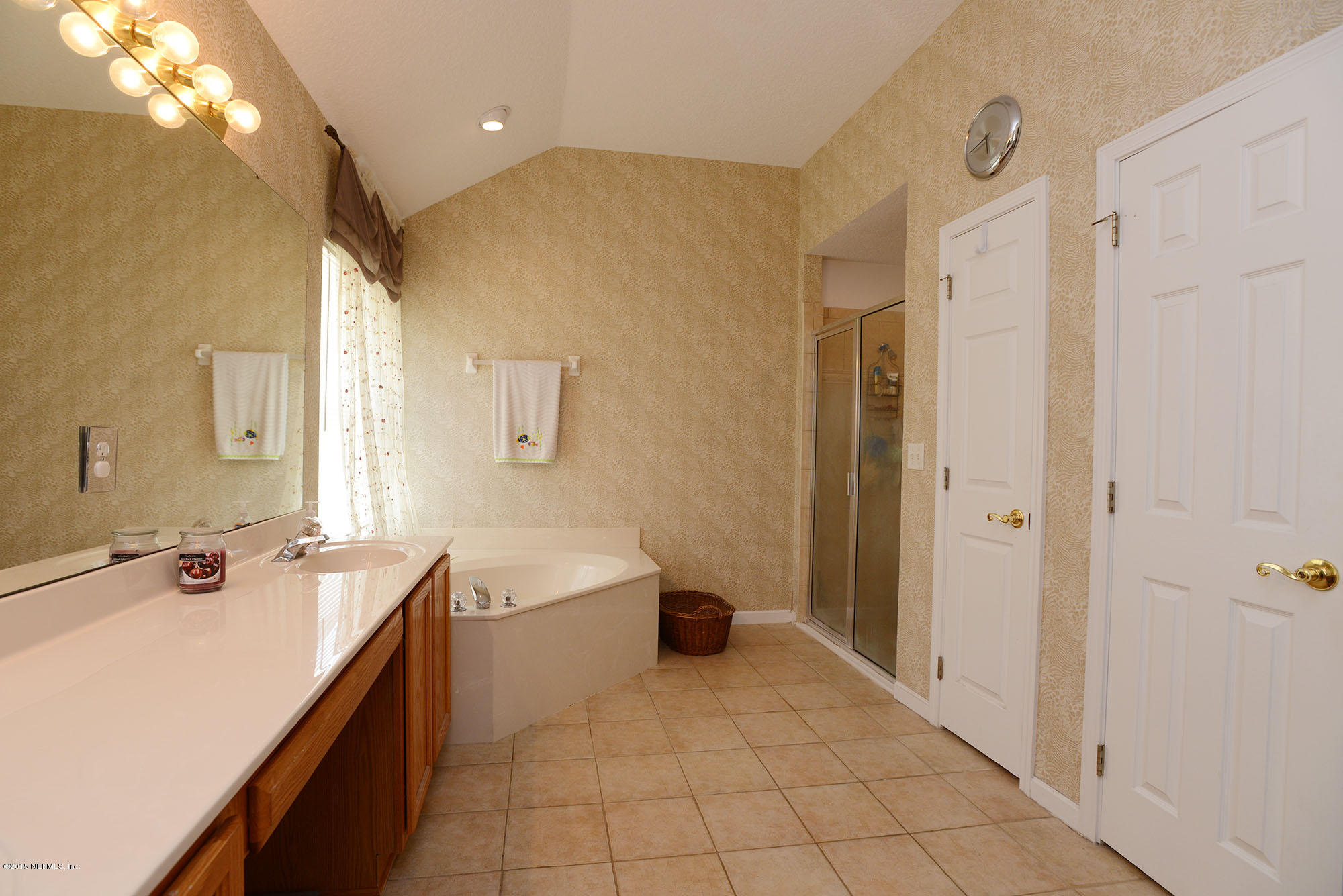 226 Riviera Boulevard St. Augustine Shores, FL 32086 - Photo 15 of 26 a spacious bathroom with a tub sink and mirror