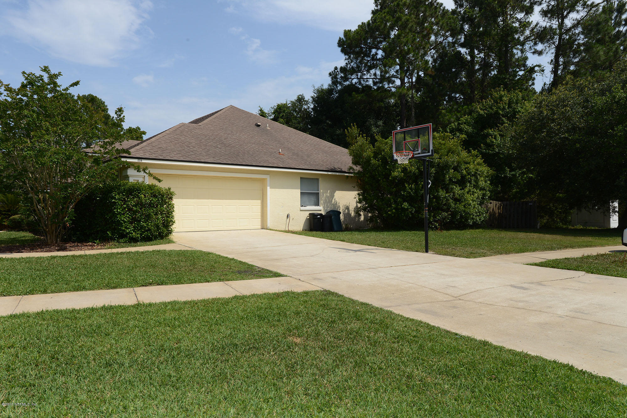 226 Riviera Boulevard St. Augustine Shores, FL 32086 - Photo 26 of 26 a house with green field in front of it