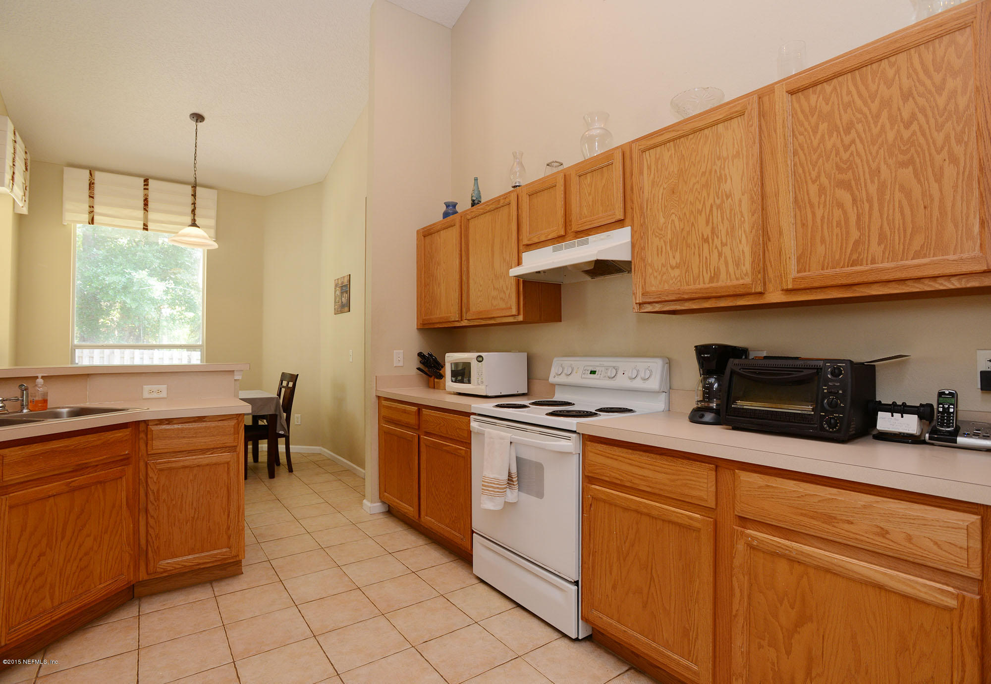 226 Riviera Boulevard St. Augustine Shores, FL 32086 - Photo 10 of 26 a kitchen with stainless steel appliances granite countertop a sink a stove and cabinets