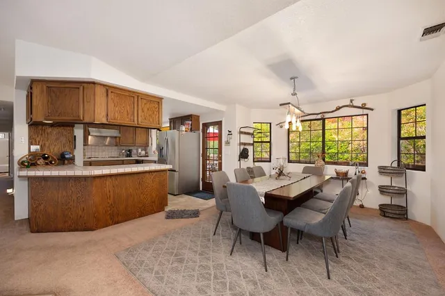 a kitchen with stainless steel appliances granite countertop a refrigerator and a stove top oven