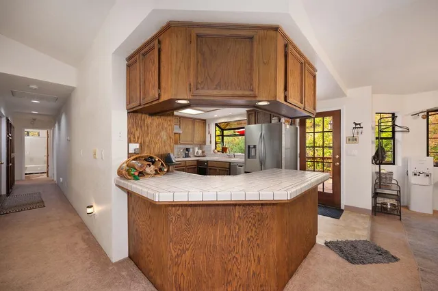 a kitchen with granite countertop cabinets stainless steel appliances and dining table view
