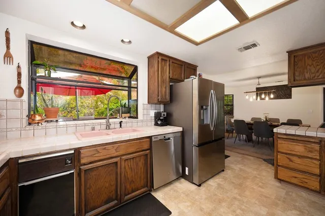 a living room with furniture a couch and a dresser with wooden floor