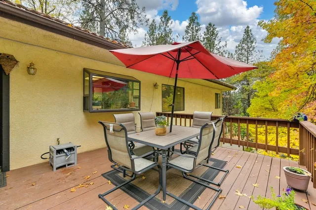 a view of a patio with couches and table and chairs and potted plants