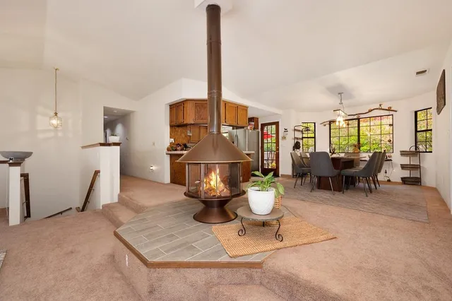 a kitchen with stainless steel appliances granite countertop a sink a stove and a refrigerator