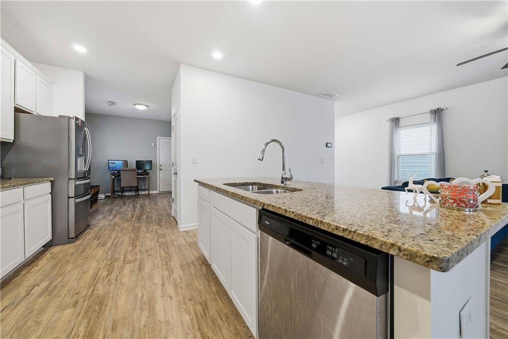 4000 Lake Manor Way Atlanta, GA 30349 - Photo 12 of 36 a kitchen with sink refrigerator and cabinets
