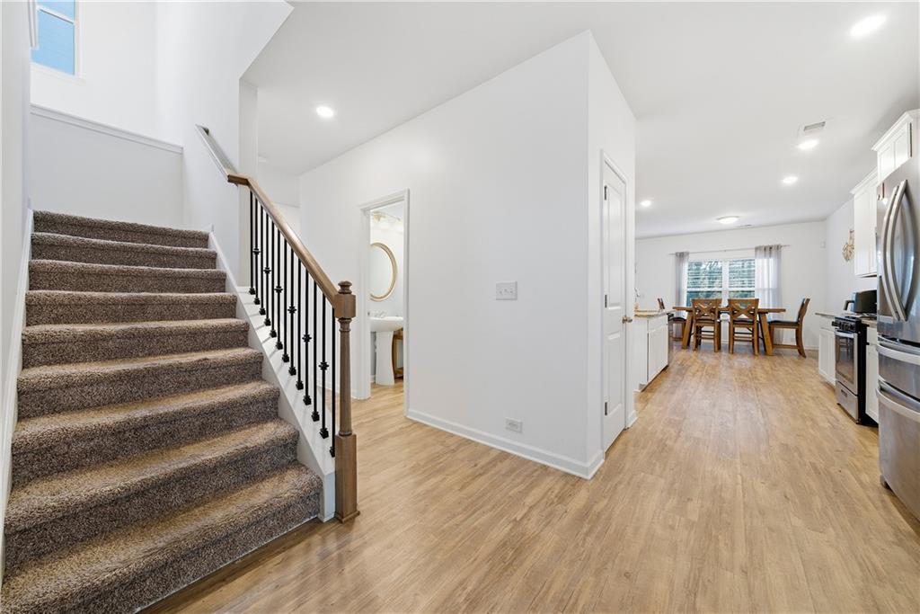4000 Lake Manor Way Atlanta, GA 30349 - Photo 17 of 36 a view of a hallway with wooden floor and furniture