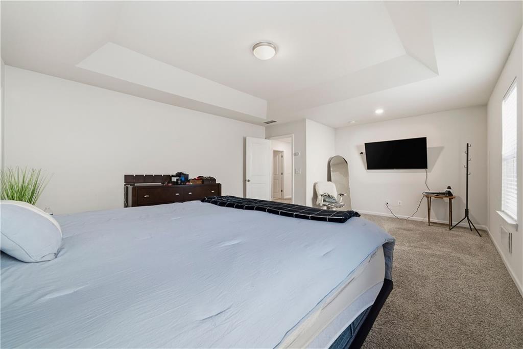 4000 Lake Manor Way Atlanta, GA 30349 - Photo 22 of 36 a bed room with furniture and a flat screen tv