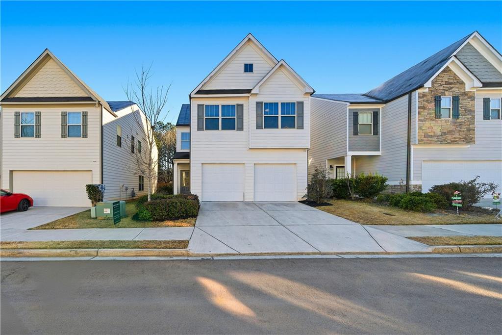 4000 Lake Manor Way Atlanta, GA 30349 - Photo 36 of 36 a front view of a house with a yard and garage