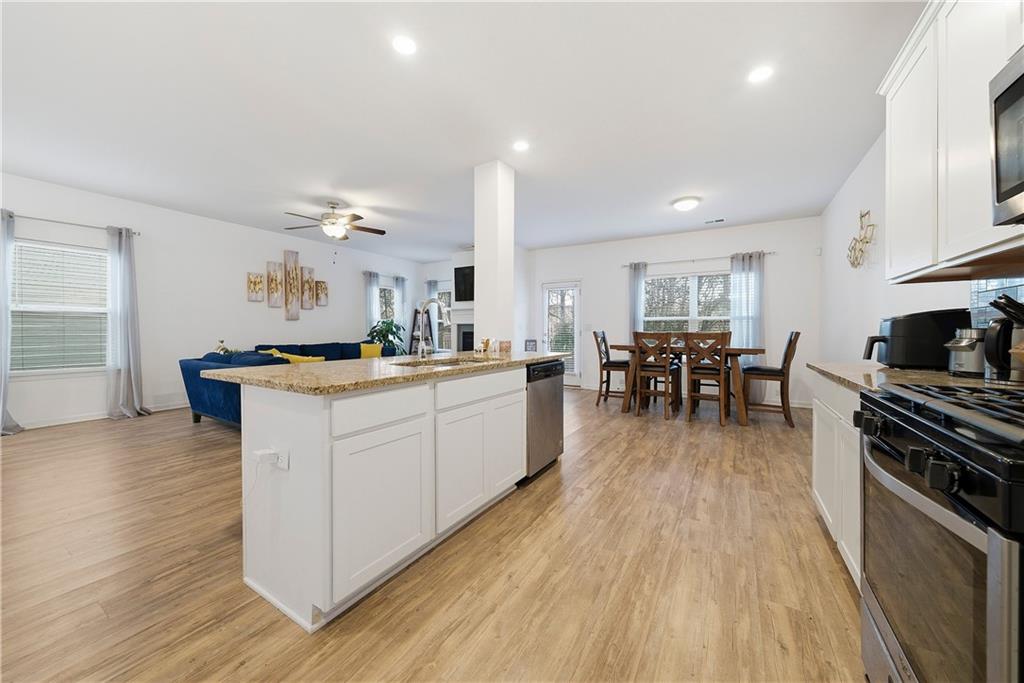 4000 Lake Manor Way Atlanta, GA 30349 - Photo 6 of 36 a kitchen with counter top space a sink appliances and cabinets