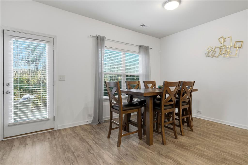 4000 Lake Manor Way Atlanta, GA 30349 - Photo 10 of 36 a view of a dining room with furniture and wooden floor