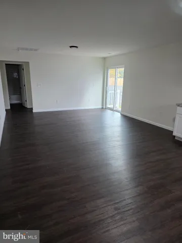 a view of wooden floor and windows in a room