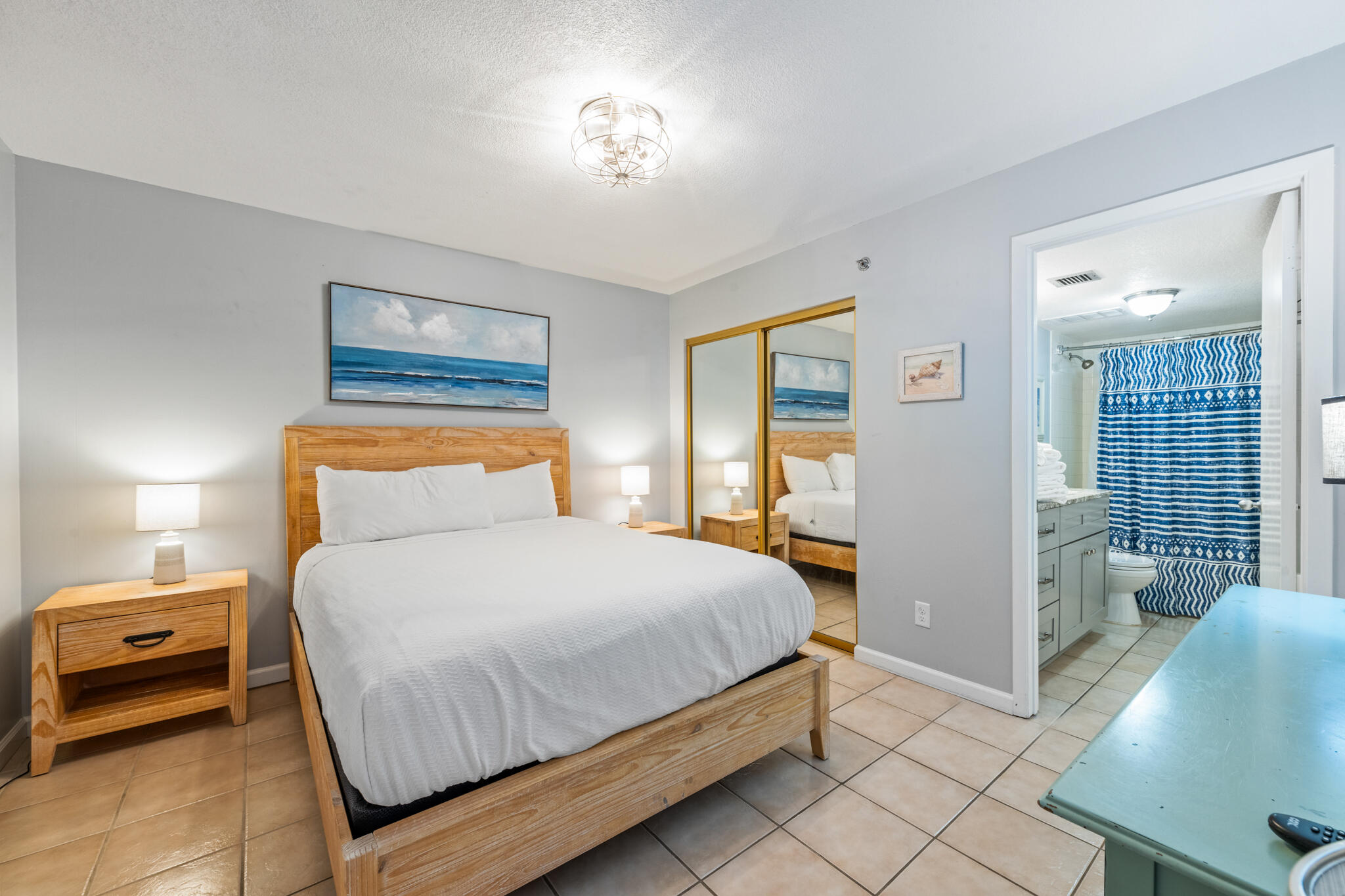 1114 Santa Rosa Boulevard, Unit 309 Fort Walton Beach, FL 32548 - Photo 12 of 52 a bedroom with a bed and a lamp