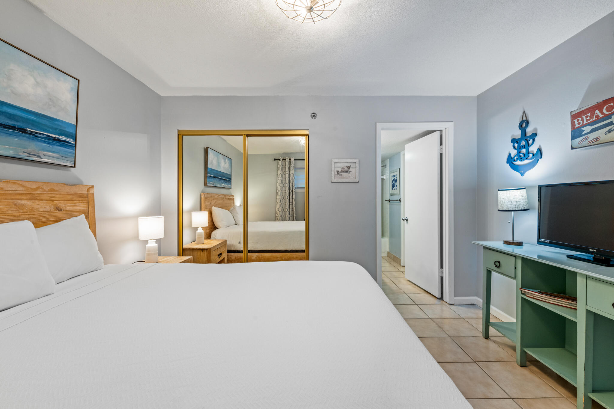 1114 Santa Rosa Boulevard, Unit 309 Fort Walton Beach, FL 32548 - Photo 15 of 52 a bedroom with a bed and a flat screen tv