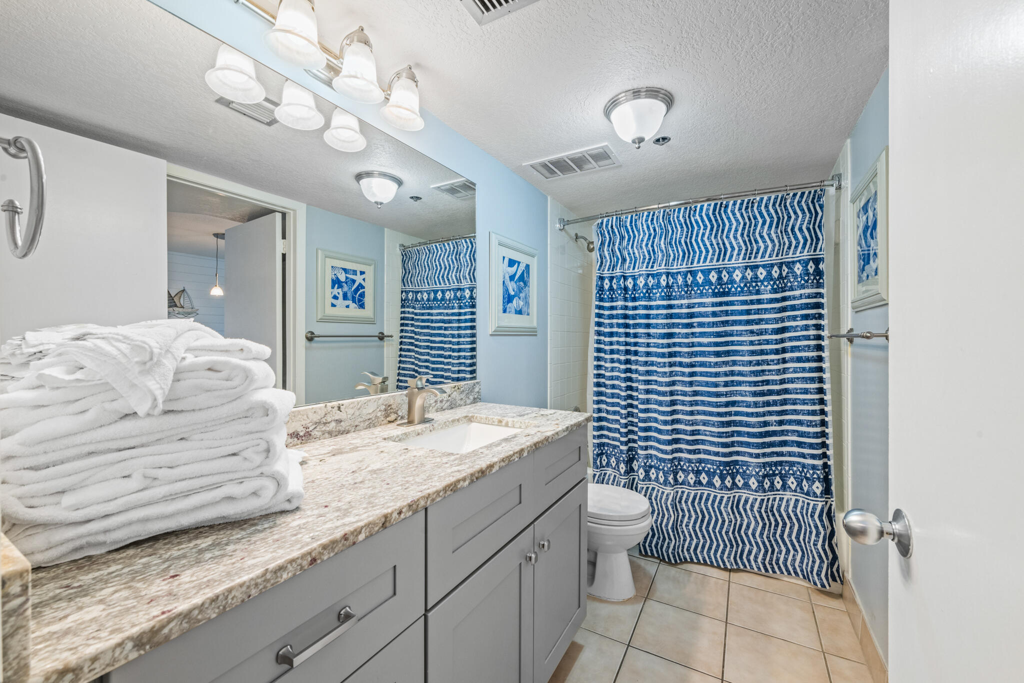 1114 Santa Rosa Boulevard, Unit 309 Fort Walton Beach, FL 32548 - Photo 17 of 52 a spacious bathroom with a granite countertop sink a toilet and shower