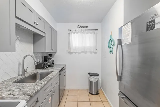 a bathroom with a granite countertop double sink and a mirror