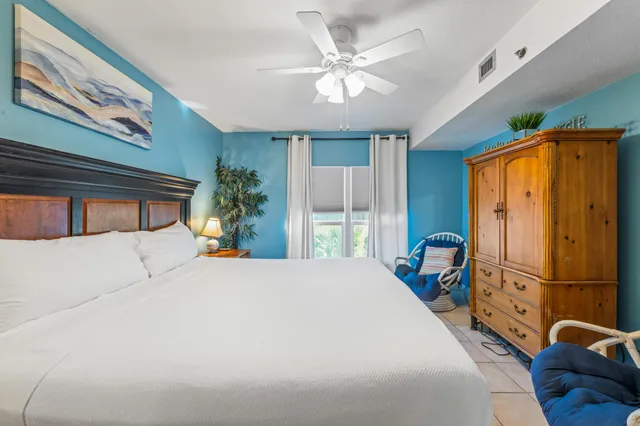 a bedroom with a bed and ceiling fan