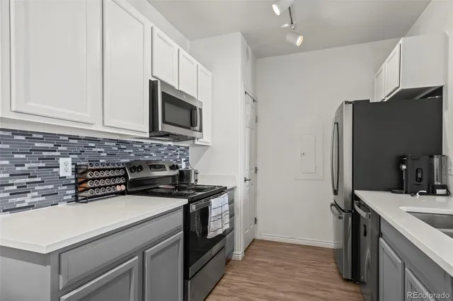 a kitchen with a sink stove and refrigerator