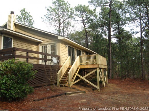 3 Pine Ridge Road Jackson Springs, NC 27281 - Photo 4 of 11 a view of a wooden deck next to a yard