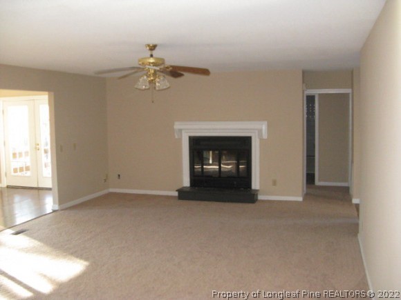 3 Pine Ridge Road Jackson Springs, NC 27281 - Photo 8 of 11 an empty room with windows and fireplace