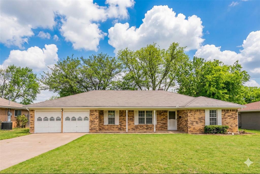 a view of a house with a yard and potted plants