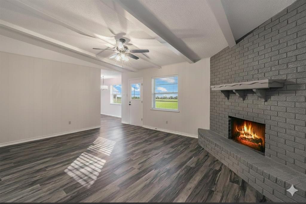 6248 Trail Lake Drive Fort Worth, TX 76133 - Photo 11 of 28 a view of a livingroom with a fireplace a ceiling fan and wooden floor