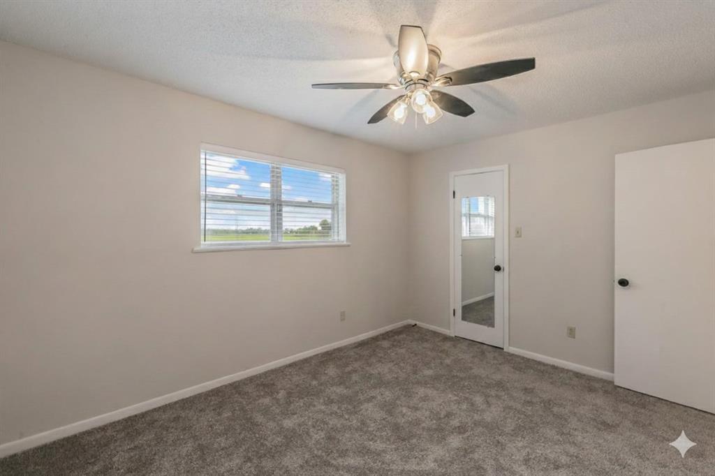 6248 Trail Lake Drive Fort Worth, TX 76133 - Photo 17 of 28 an empty room with windows and fan