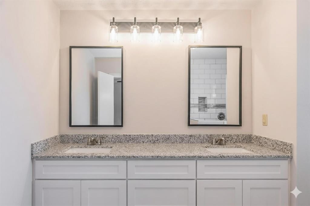 6248 Trail Lake Drive Fort Worth, TX 76133 - Photo 19 of 28 a bathroom with a granite countertop sink and a mirror