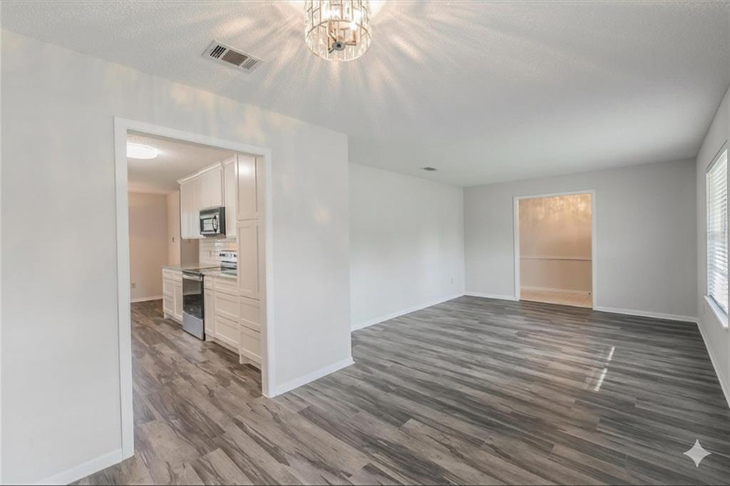 6248 Trail Lake Drive Fort Worth, TX 76133 - Photo 5 of 28 a view of a room with wooden floor and a window
