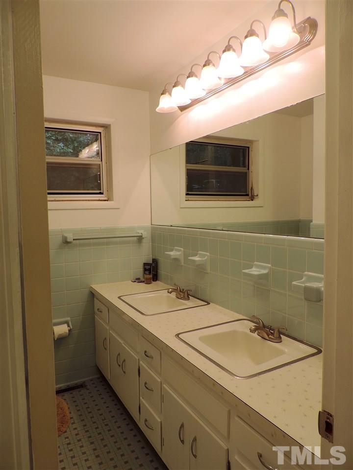 1303 Lorimer Road Raleigh, NC 27606 - Photo 11 of 13 a bathroom with a sink and a mirror
