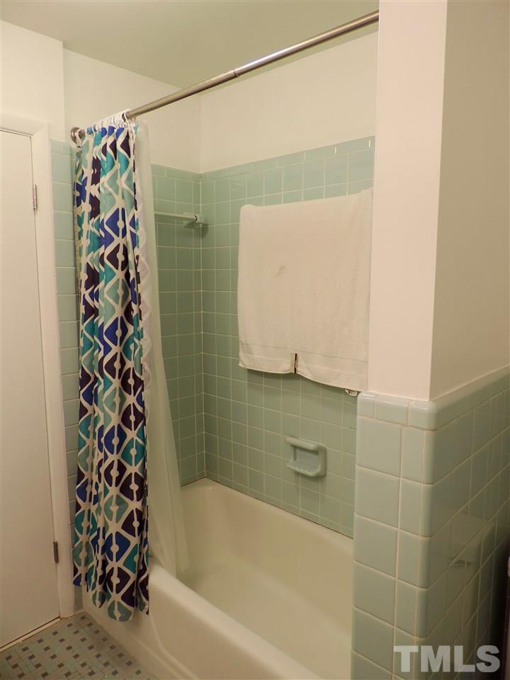 1303 Lorimer Road Raleigh, NC 27606 - Photo 12 of 13 a bathroom with a bathtub and shower