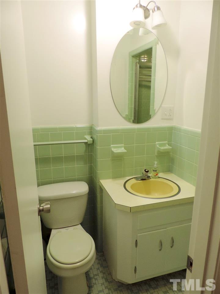1303 Lorimer Road Raleigh, NC 27606 - Photo 13 of 13 a bathroom with a toilet sink and mirror