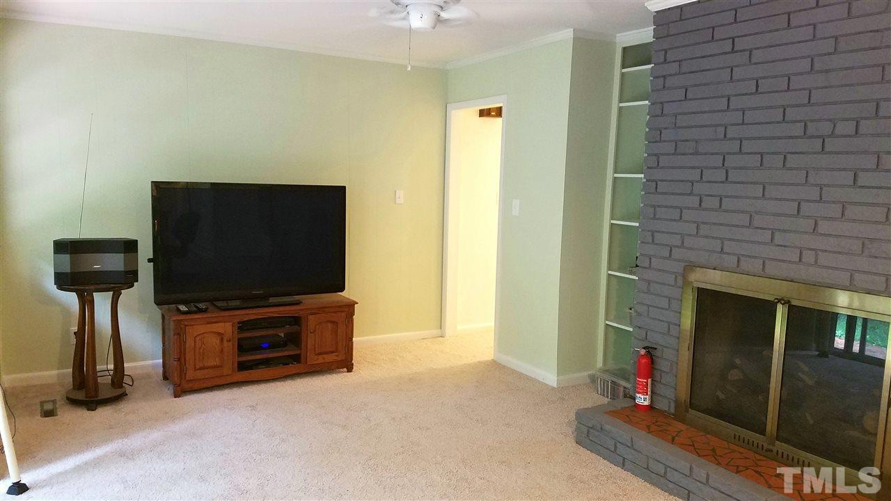 1303 Lorimer Road Raleigh, NC 27606 - Photo 5 of 13 a living room with furniture and a flat screen tv