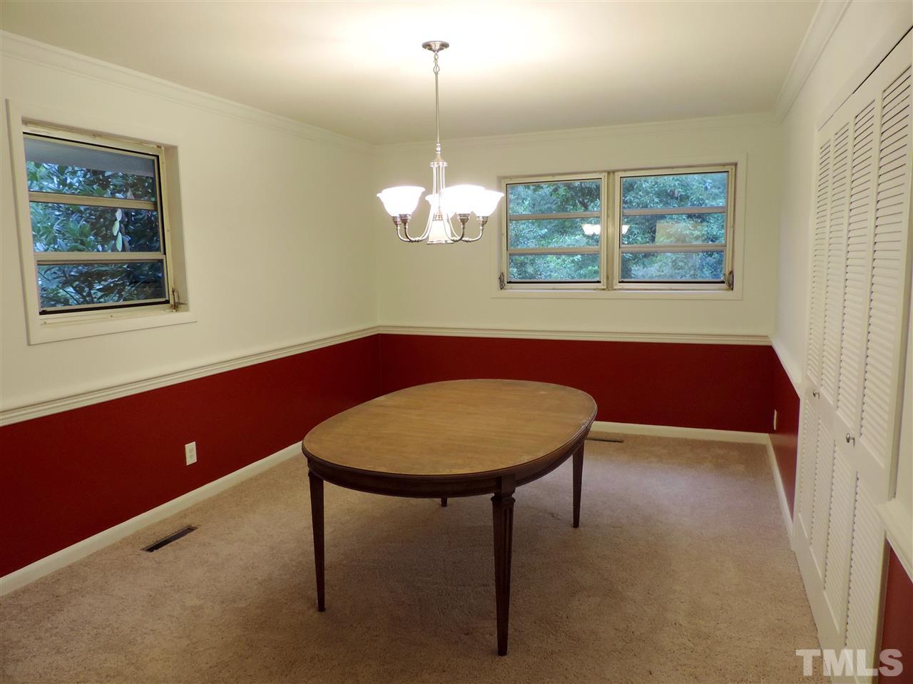 1303 Lorimer Road Raleigh, NC 27606 - Photo 6 of 13 a view of a room with a chandelier and wooden floor