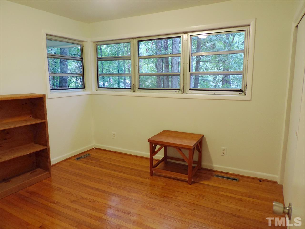 1303 Lorimer Road Raleigh, NC 27606 - Photo 9 of 13 a view of a room with wooden floor and a window