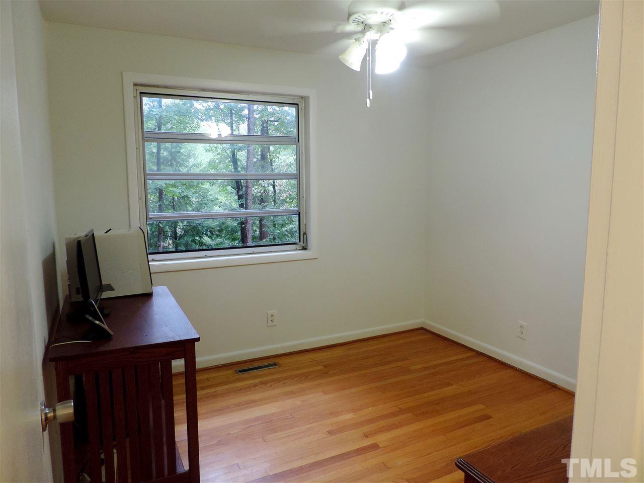 1303 Lorimer Road Raleigh, NC 27606 - Photo 10 of 13 a view of a workspace with furniture and a window